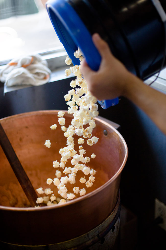 pouring popcorn into pan